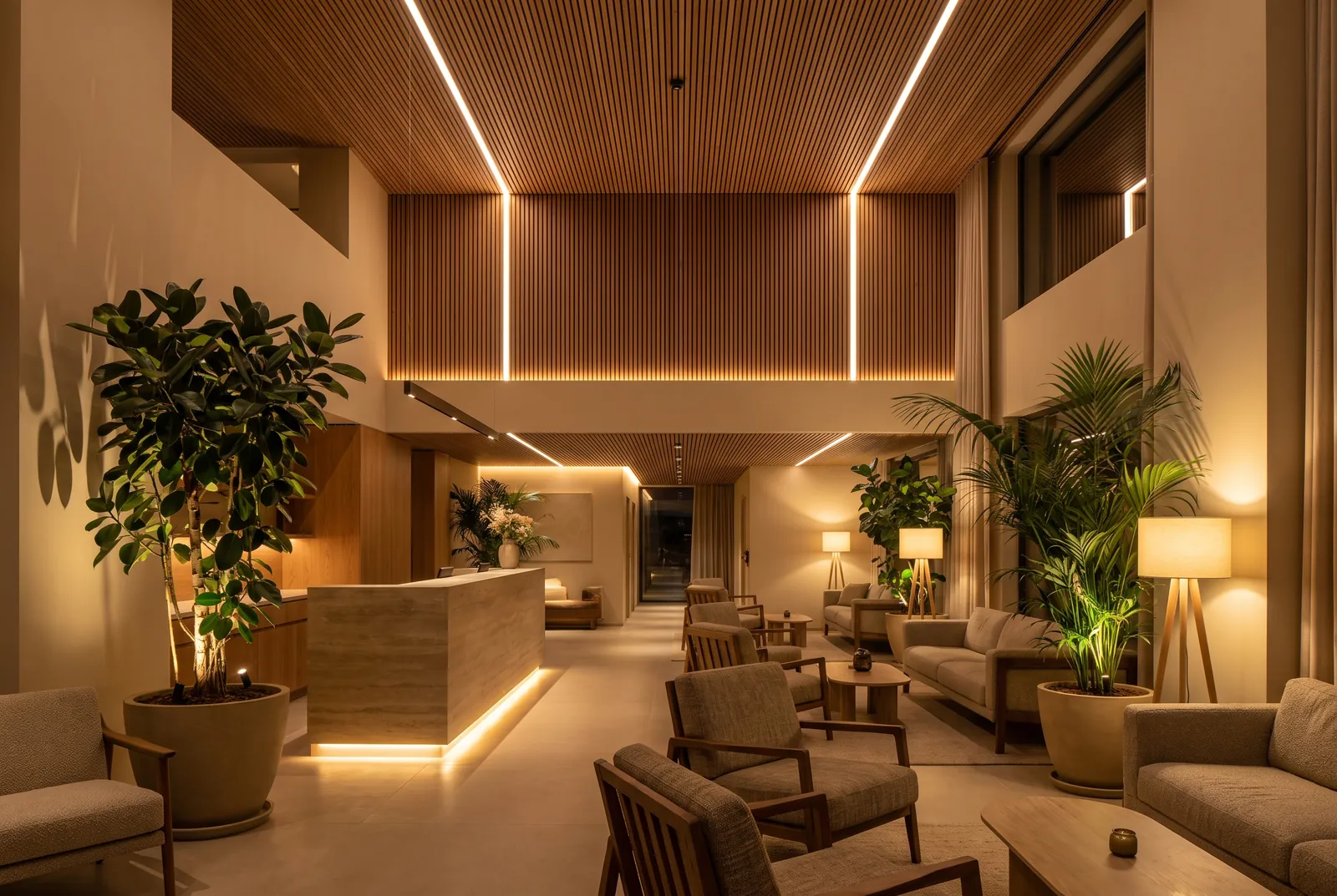 A hotel lobby with linear lights in a timber ceiling, a softly lit reception desk, lounge seating, table lamps and large plants.